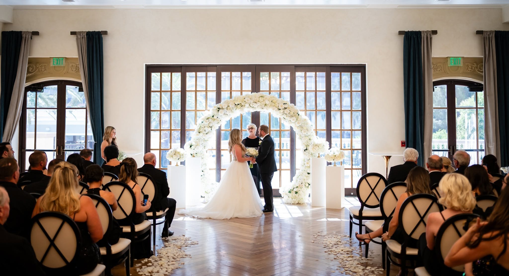 A wedding ceremony in front of the Veranda windows at The Stirling Club